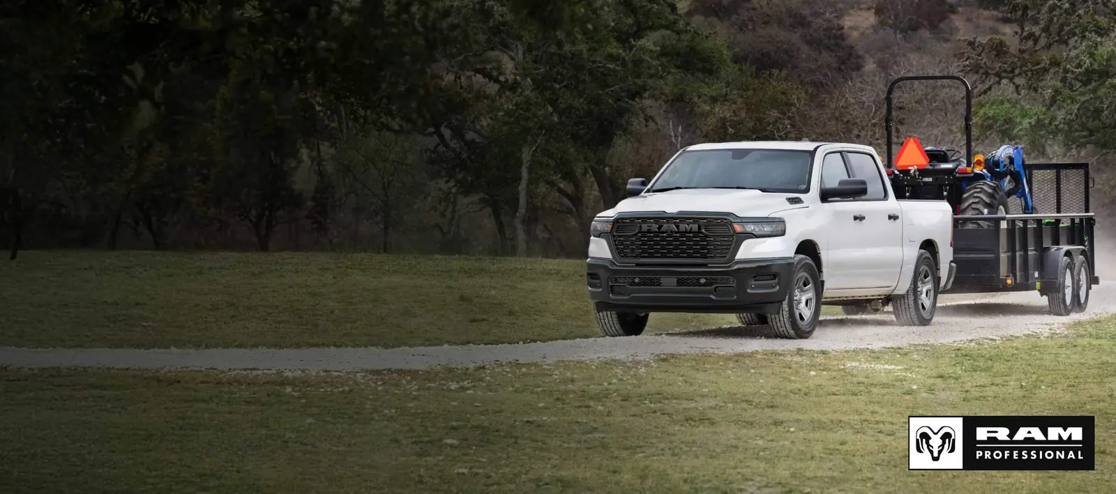2026 Ram 1500 towing a utility trailer on a rural road