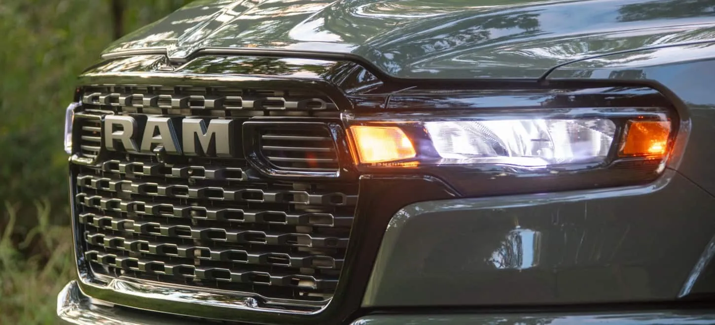 close up of a Ram 1500 front grille and headlamp