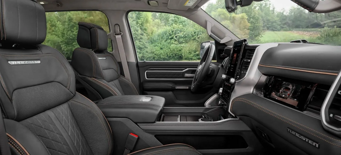 2026 Ram 1500 on an open road side and front three quarter in motion