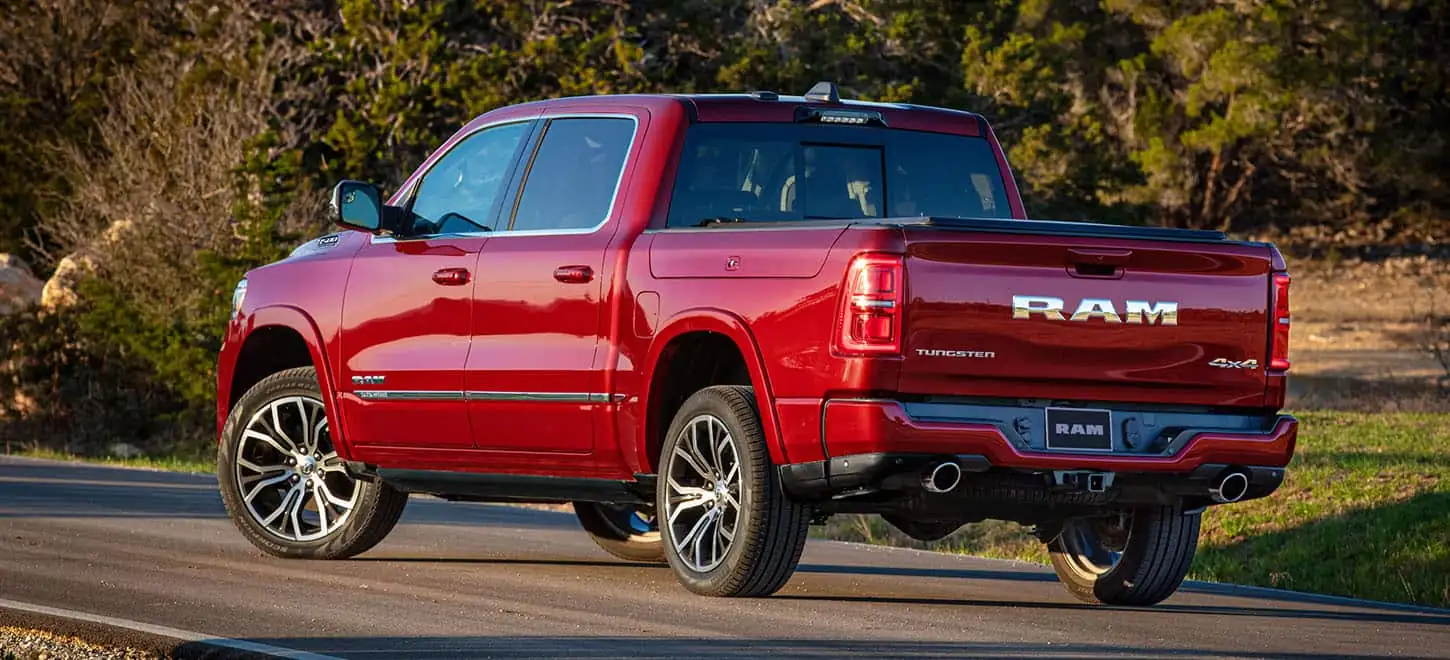 2026 Ram 1500 rear three quarter on a rural road at golden hour