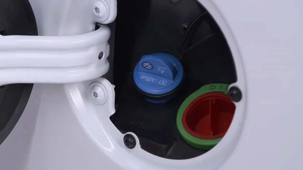 open fuel door on a Ram heavy duty diesel showing the blue DEF cap beside the green diesel-only fuel filler