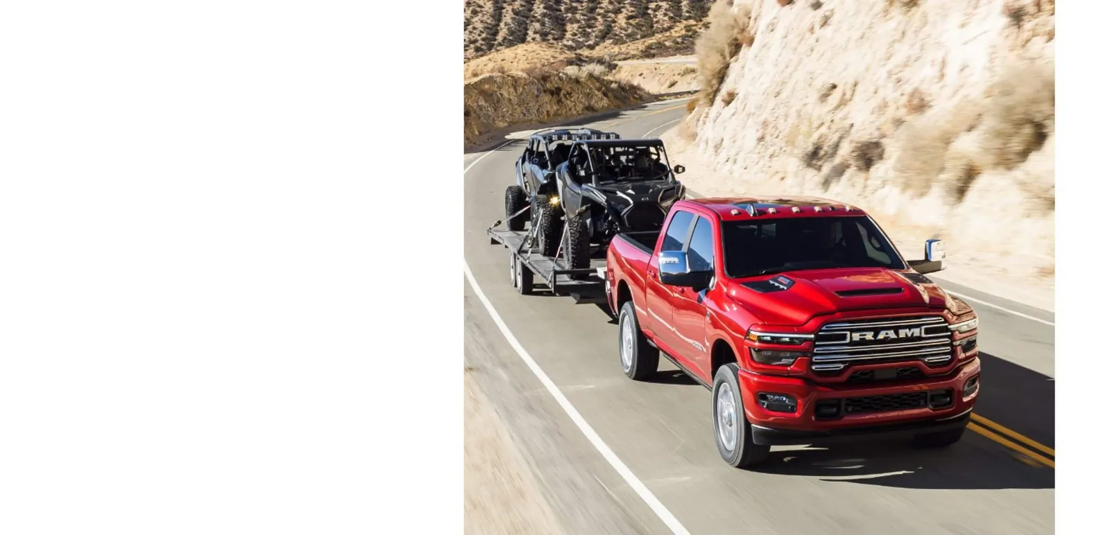 red 2026 Ram 2500 Laramie towing an open trailer with two side by sides on a highway