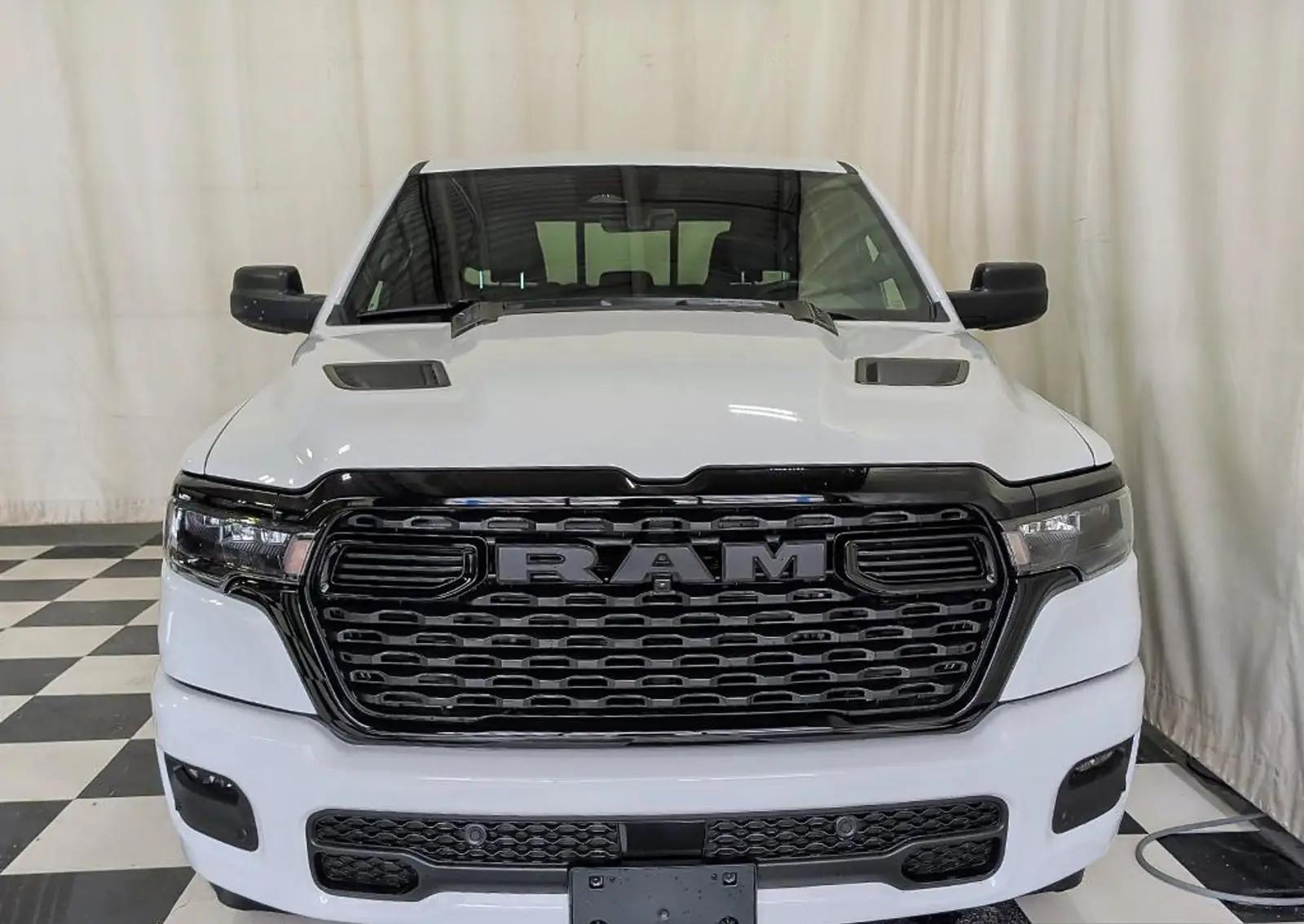Bright White Ram 1500 Express Crew Cab studio exterior shot on the dealer lot
