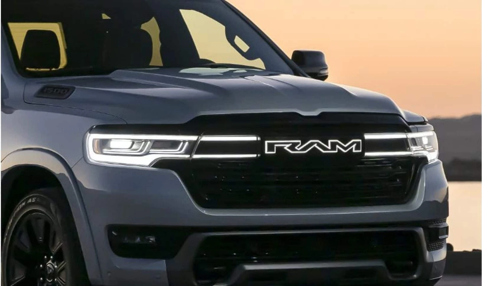 illuminated closed RAM grille and LED headlamp bar on the Ram 1500 REV