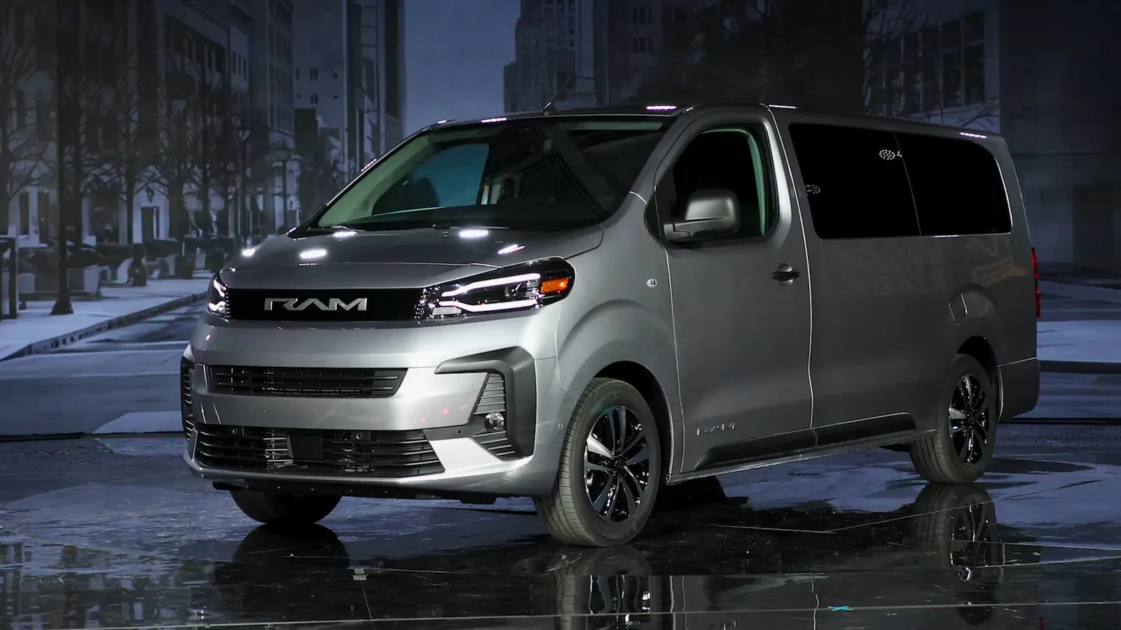 silver 2027 Ram ProMaster City SLT Passenger Wagon front three quarter view on a wet street