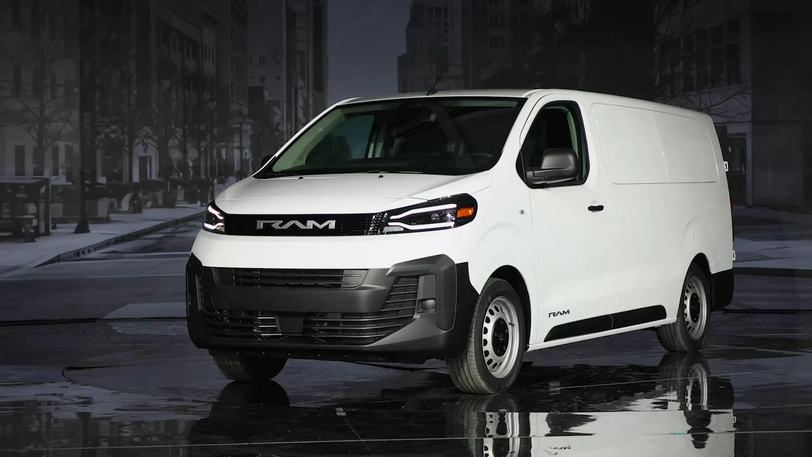 white 2027 Ram ProMaster City Tradesman Cargo Van front three quarter view on a wet street