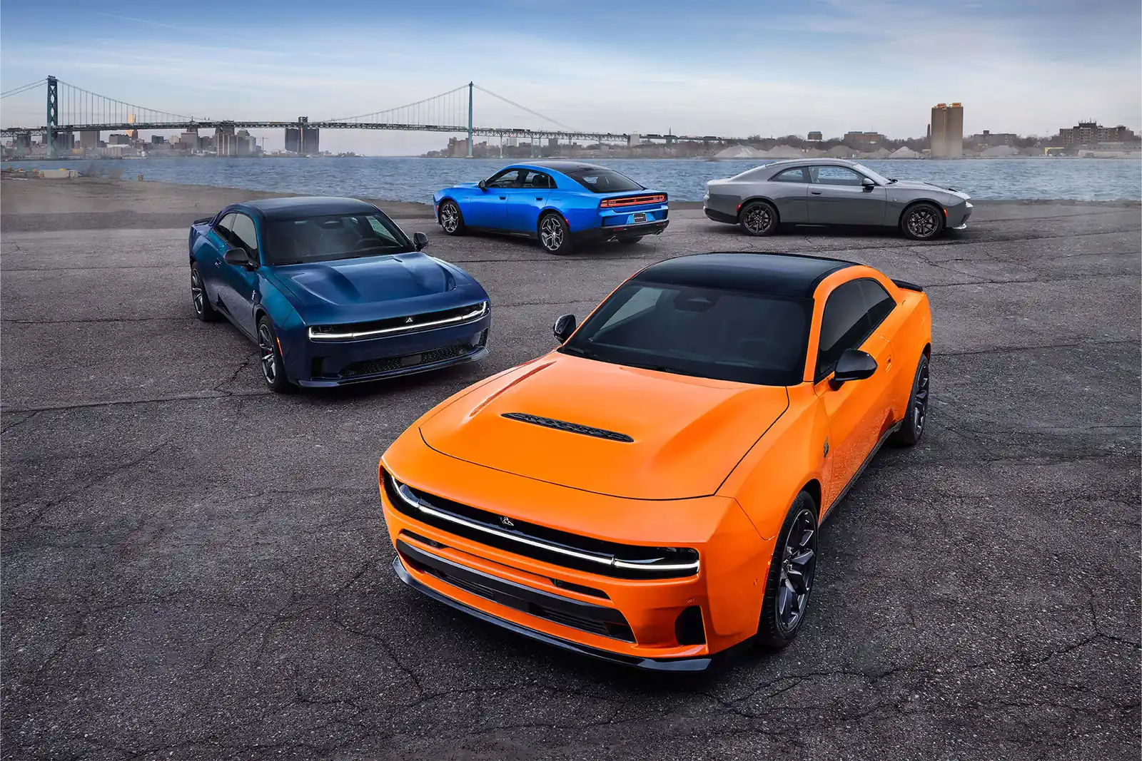 orange and blue Dodge Chargers in a front three quarter group shot