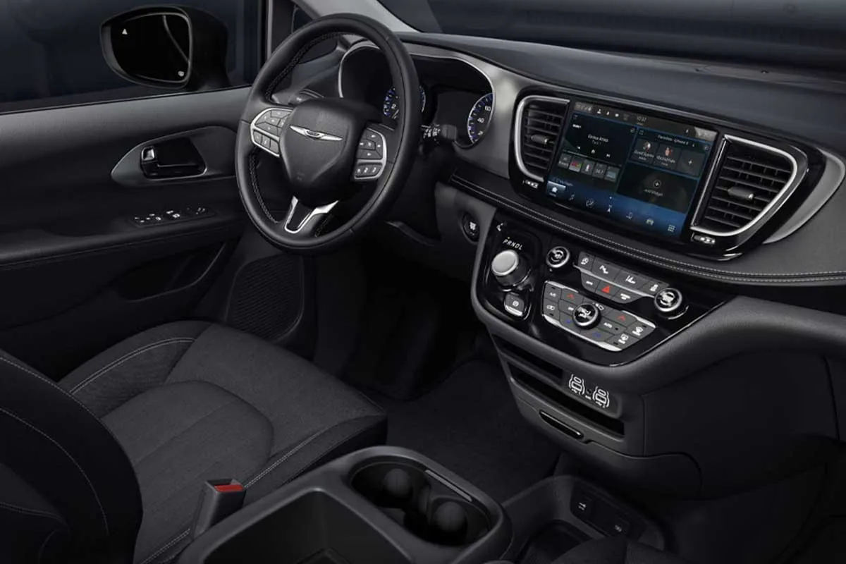 Chrysler Grand Caravan front dashboard with the Uconnect touchscreen and front seats