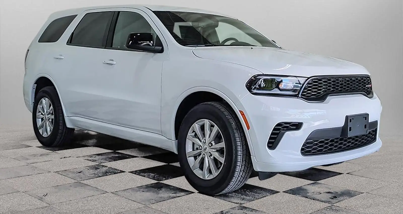 2026 Dodge Durango SXT in White Knuckle, front three quarter view in a studio photo booth