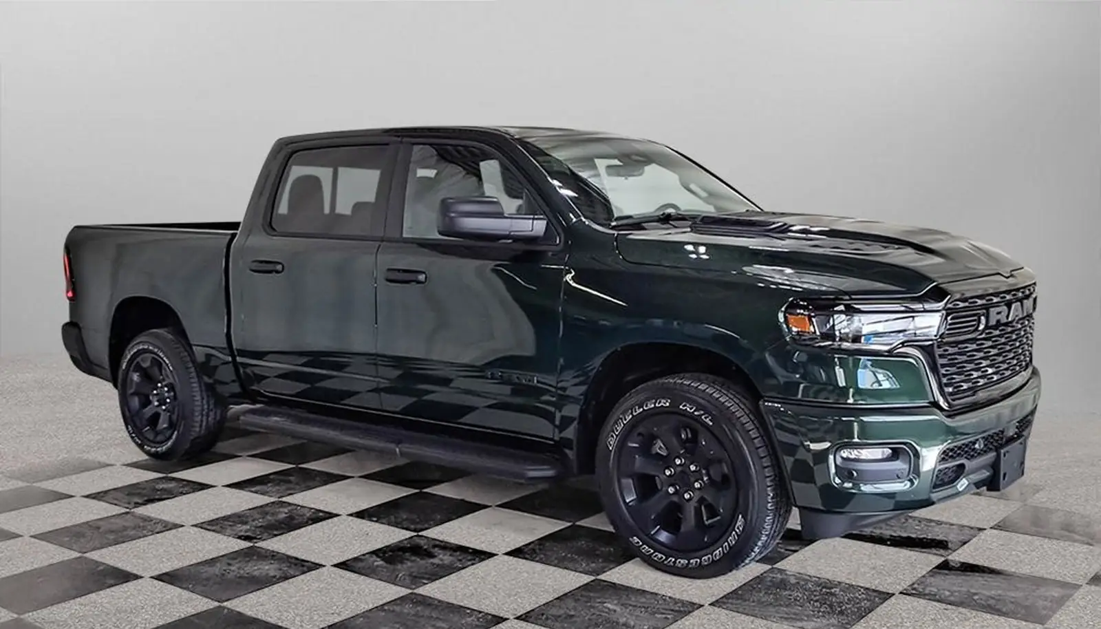 Green 2026 Ram 1500 Express Crew Cab front three quarter on the dealer lot