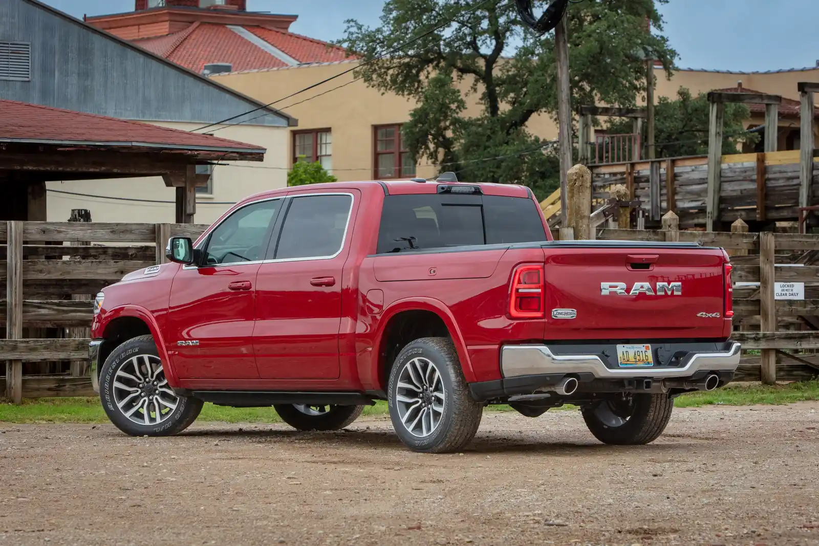 Red Ram 1500 Limited Longhorn rear three quarter on a gravel road