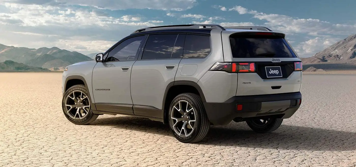 Grey 2026 Jeep Cherokee on a salt flat, rear three quarter view