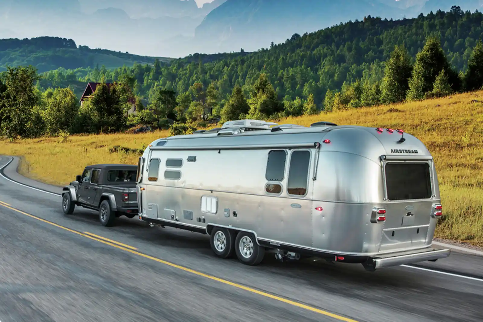 2026 Jeep Gladiator towing a trailer on a highway
