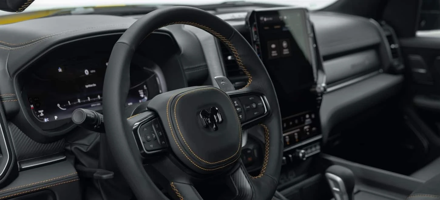 2027 Ram 1500 Rumble Bee interior cockpit with flat bottom steering wheel and centre screen