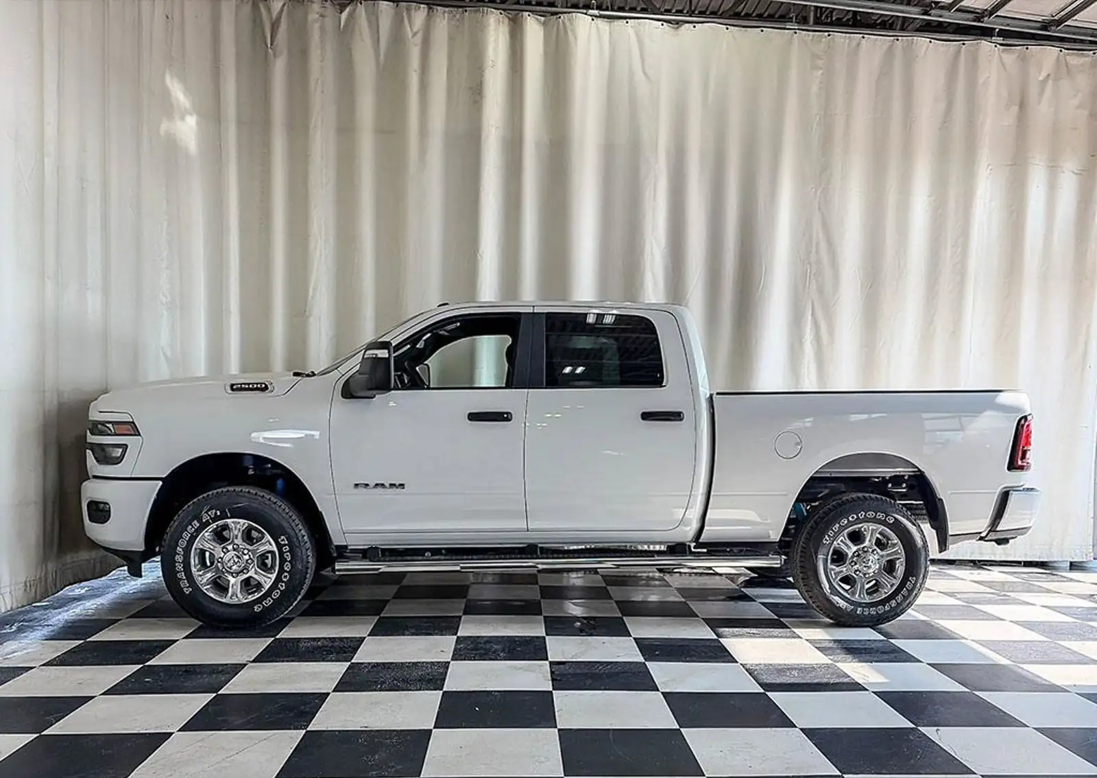 White 2026 Ram 2500 Big Horn Crew Cab body side with polished aluminum wheels