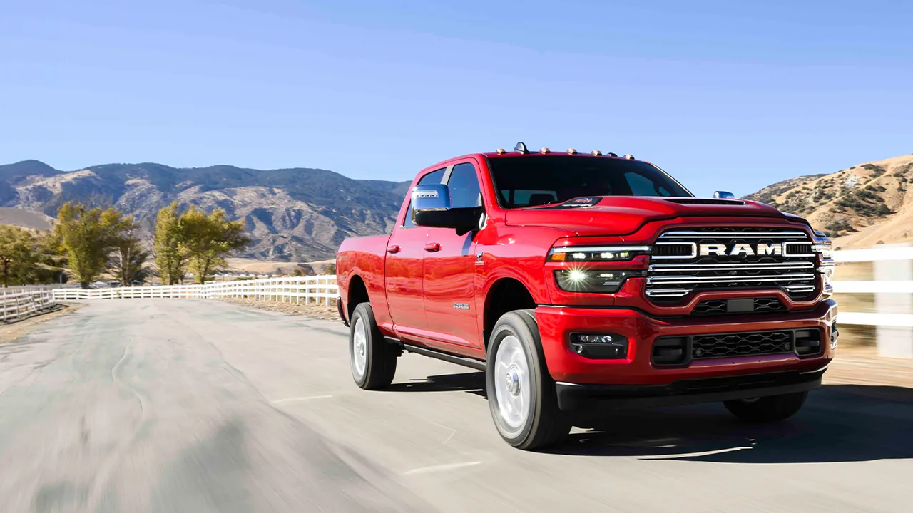 Red Ram 2500 driving an open country road, front three quarter view