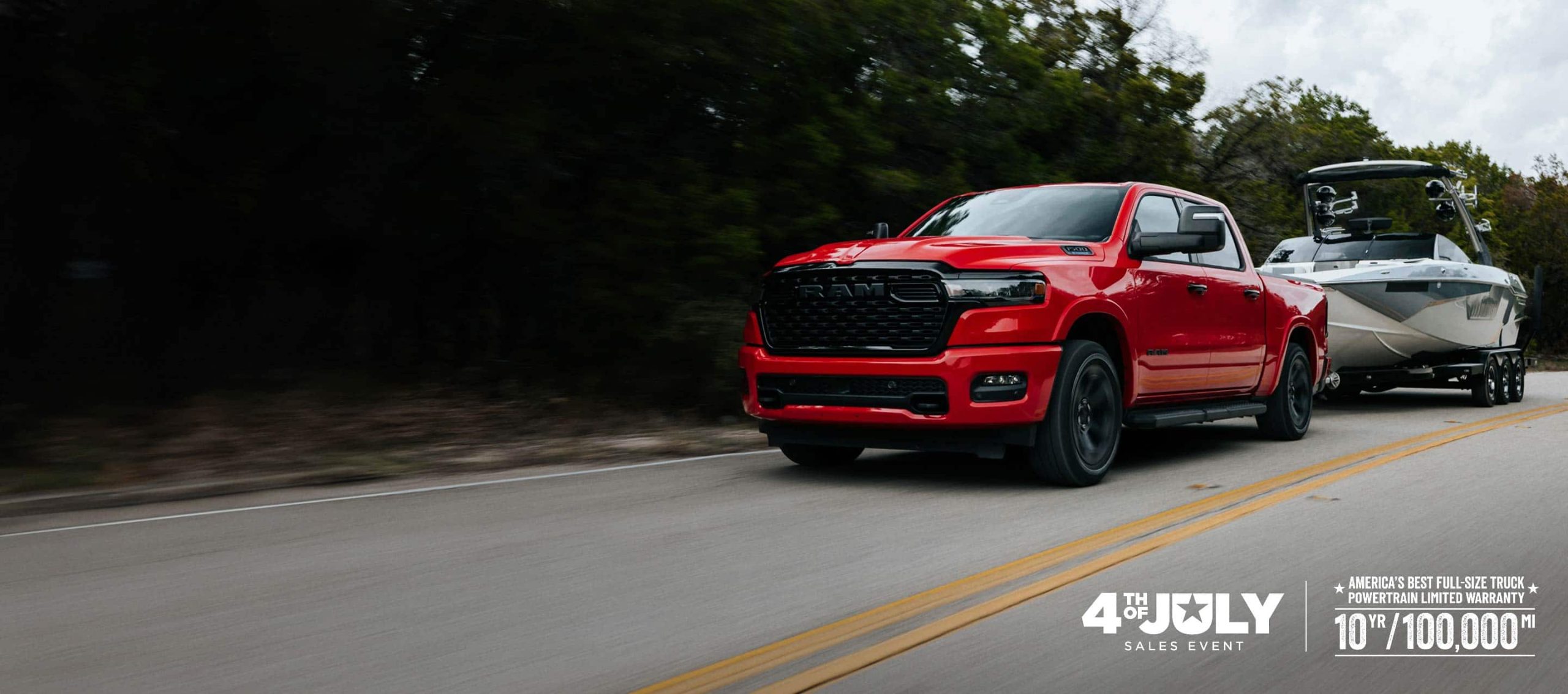 red Ram 1500 towing a boat on a highway in front three quarter motion