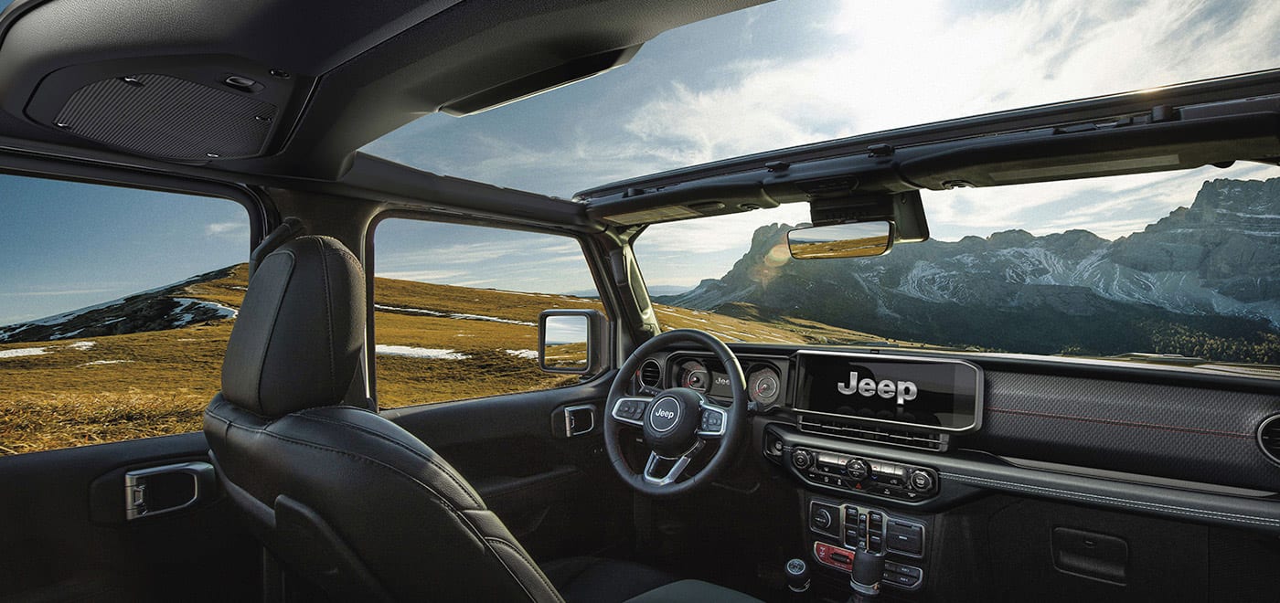 Jeep Wrangler interior cabin with the steering wheel and centre touchscreen