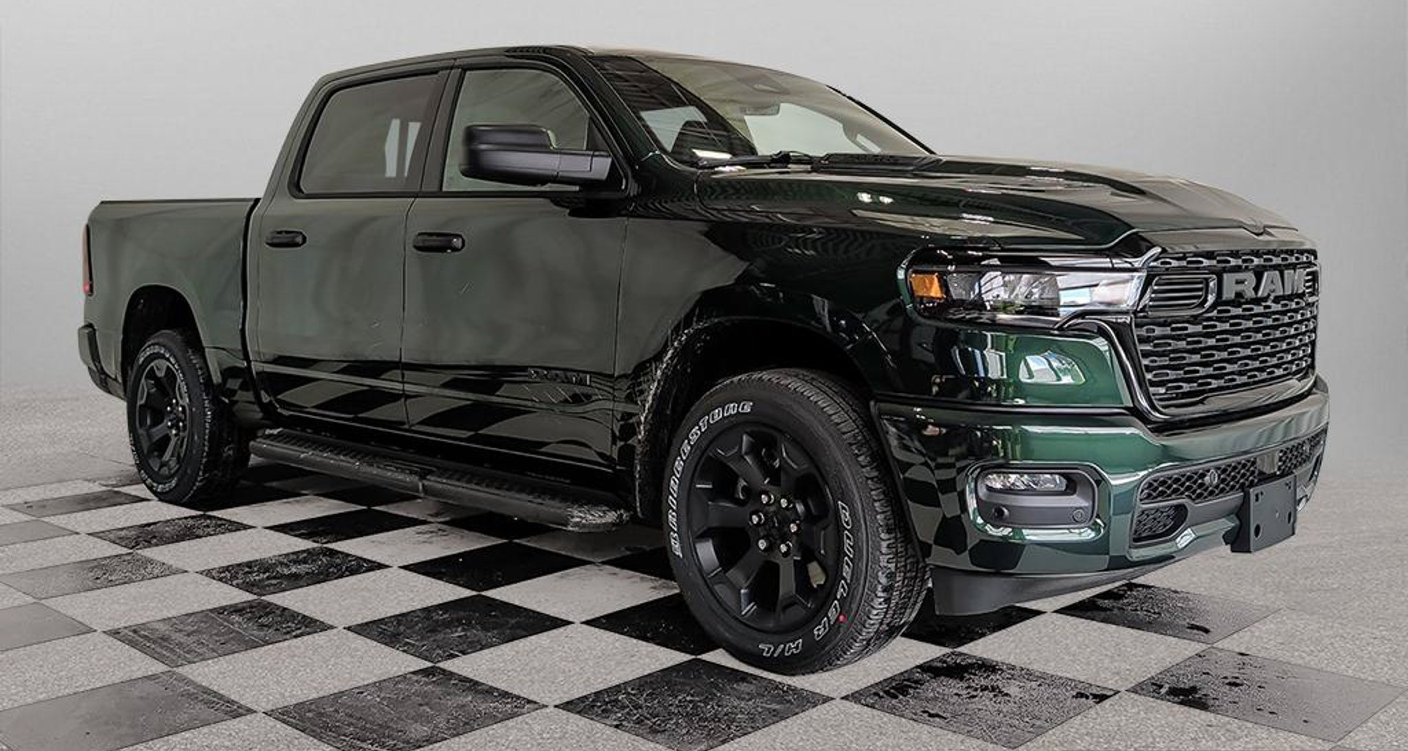 green Ram 1500 Express Crew Cab front three quarter view photographed on the dealership lot