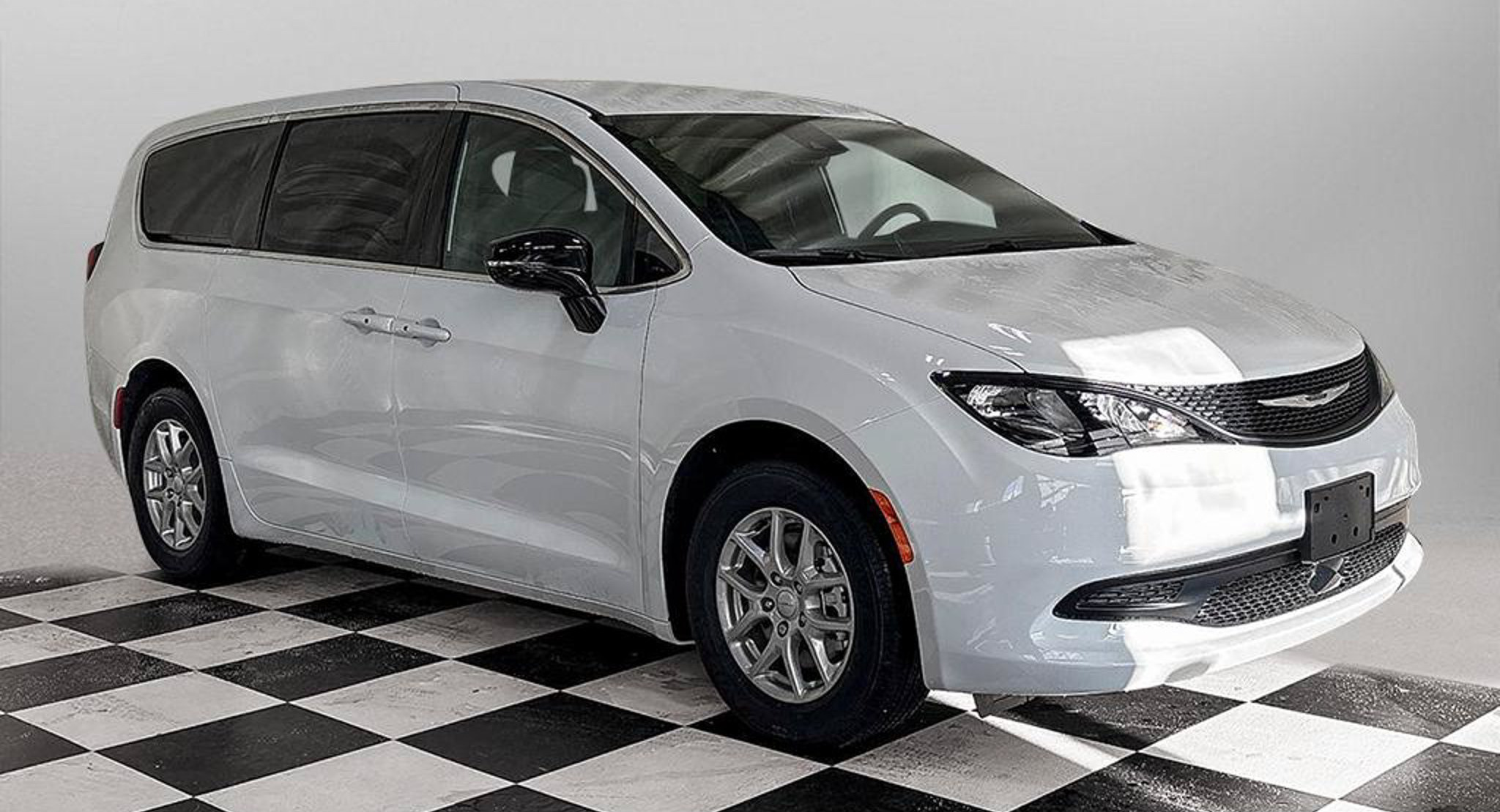 2027 Chrysler Grand Caravan SXT in Bright White, studio photo of a Dunn Ram Trucks unit