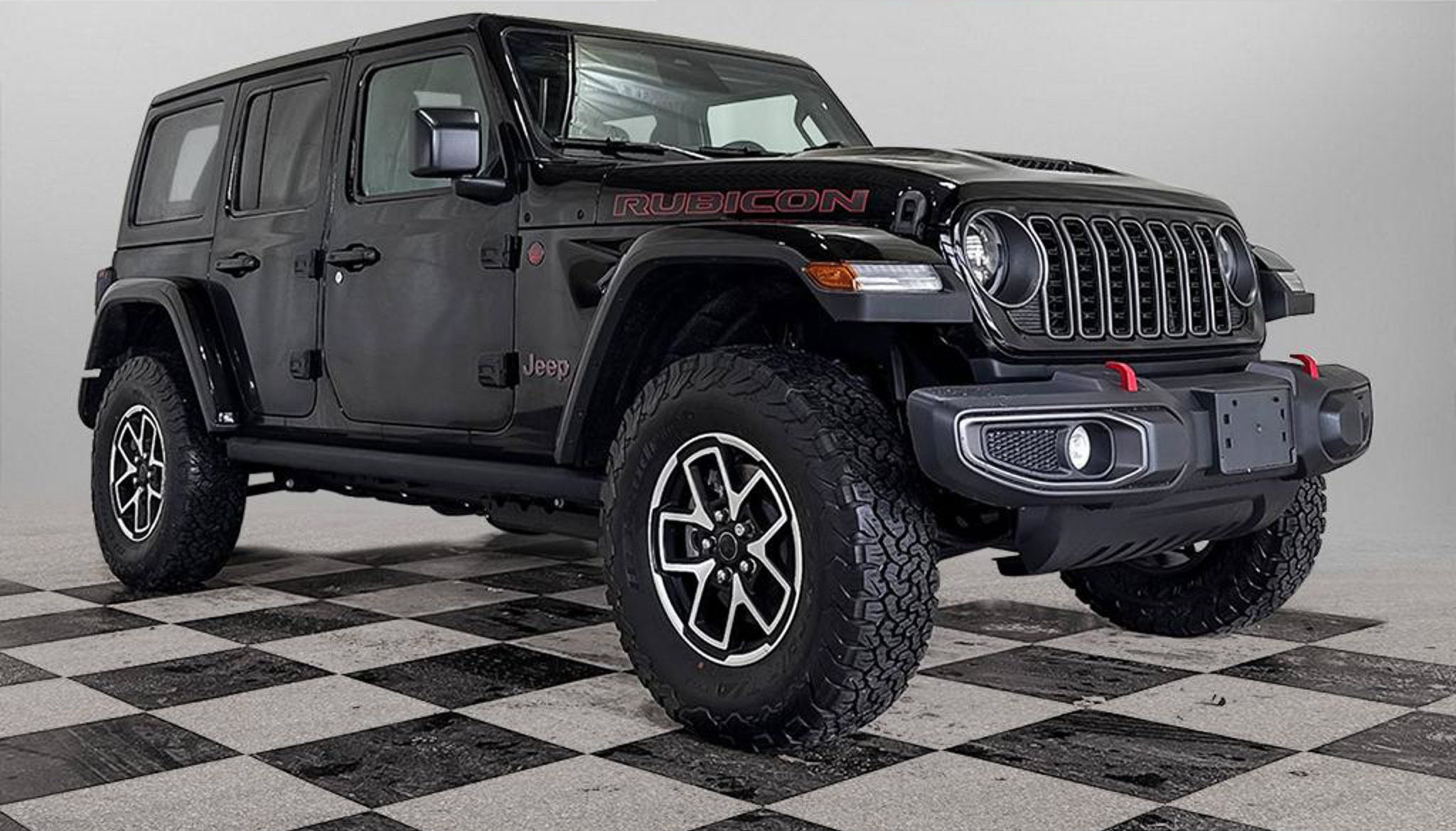 2027 Jeep Wrangler Rubicon four door in Black, studio photo of a Dunn Ram Trucks unit