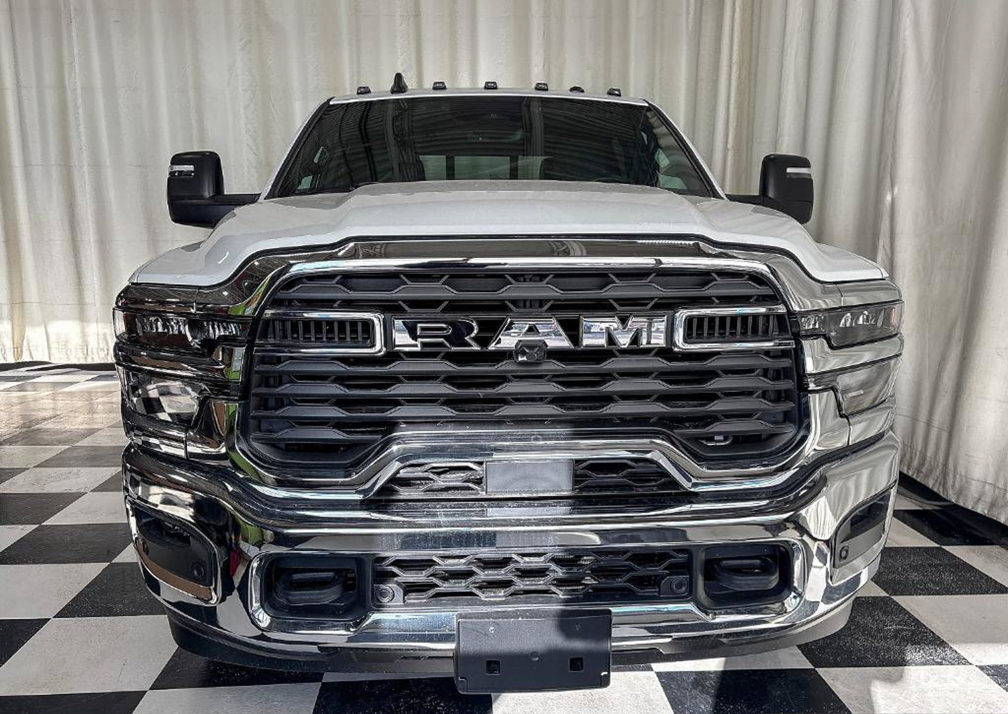 2027 Ram 3500 Tradesman Crew Cab, straight-on front view with the chrome grille, studio photo of a Dunn Ram Trucks unit