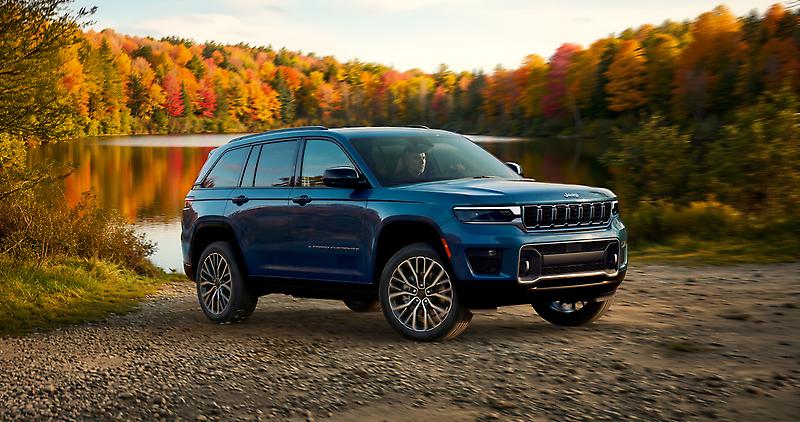 2027 Jeep Grand Cherokee Overland, front three quarter view on a lakeside trail in fall, Stellantis Canada press kit photo