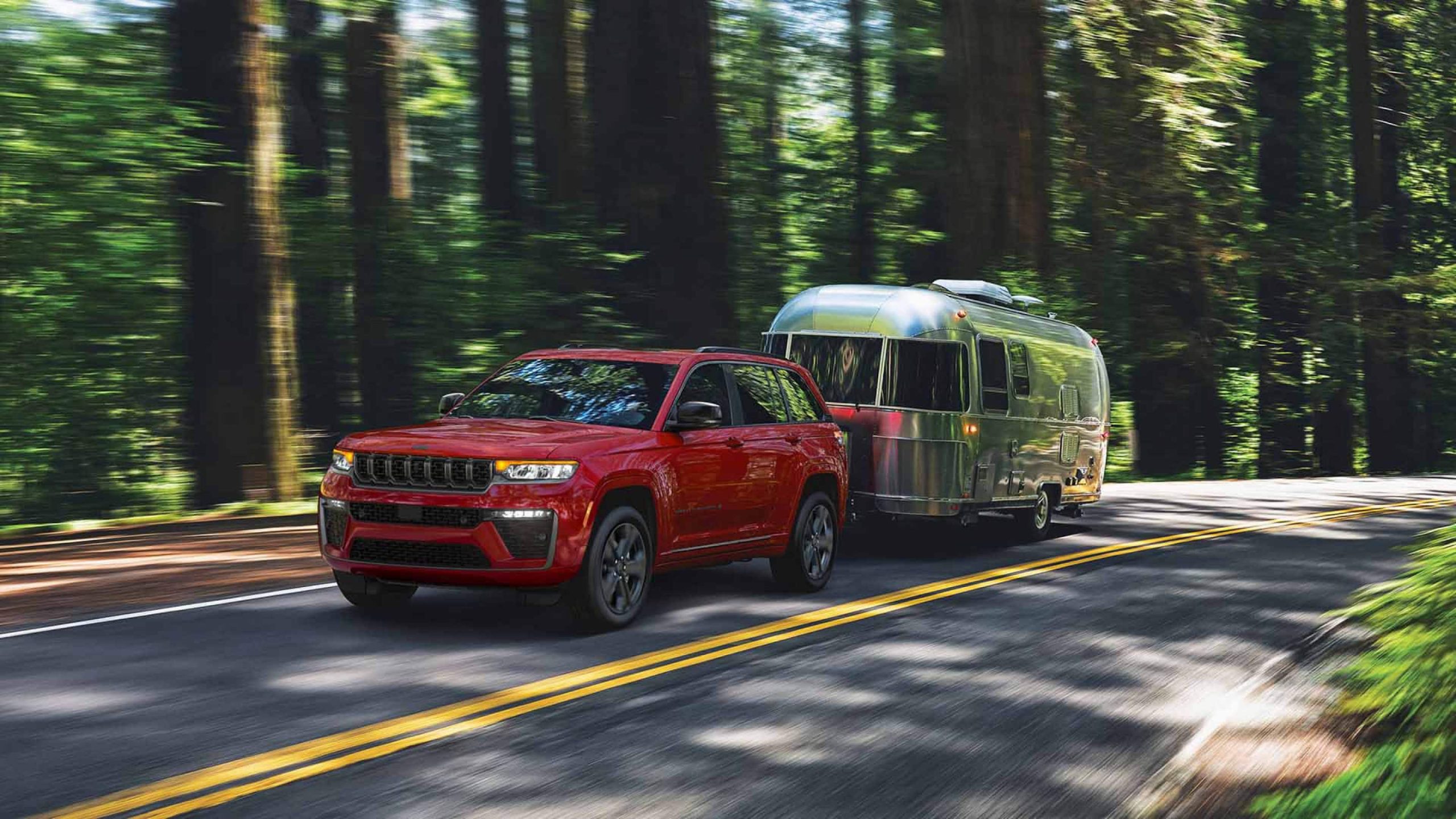 Jeep's 2027 image of the Grand Cherokee Limited Reserve towing a travel trailer
