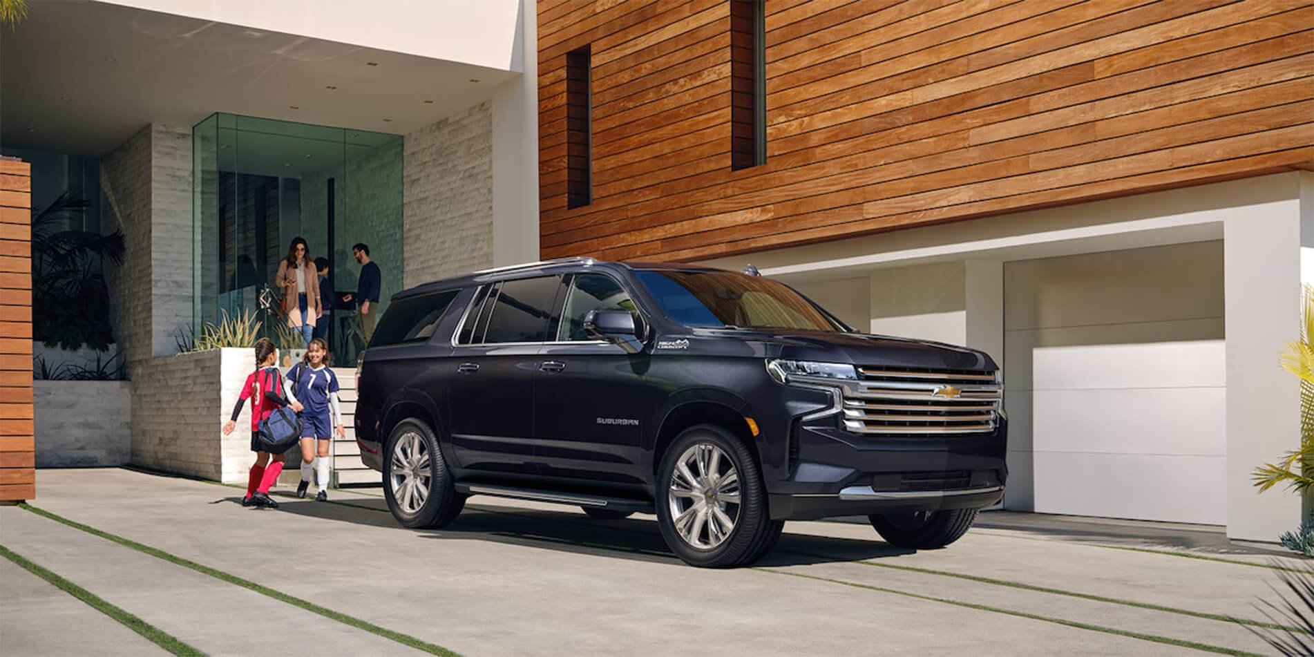 A family getting into a 2023 Chevrolet Suburban