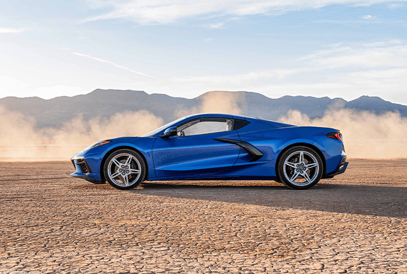 Side view of a Blue Chevrolet Covette in a desert