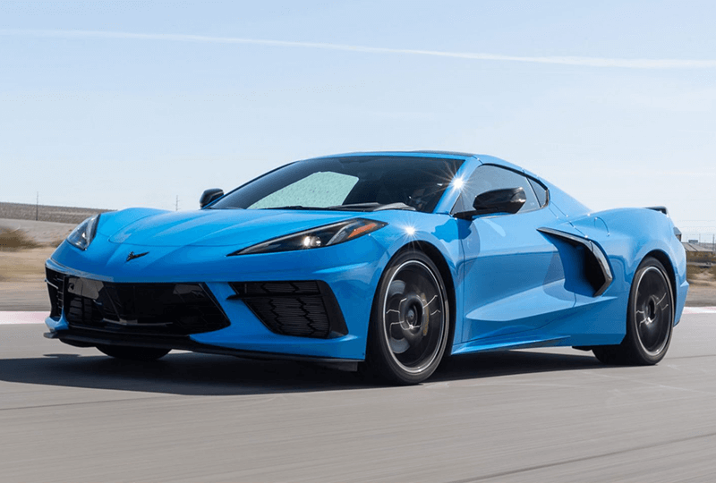 Blue 2023 Chevrolet Corvette driving at high speed