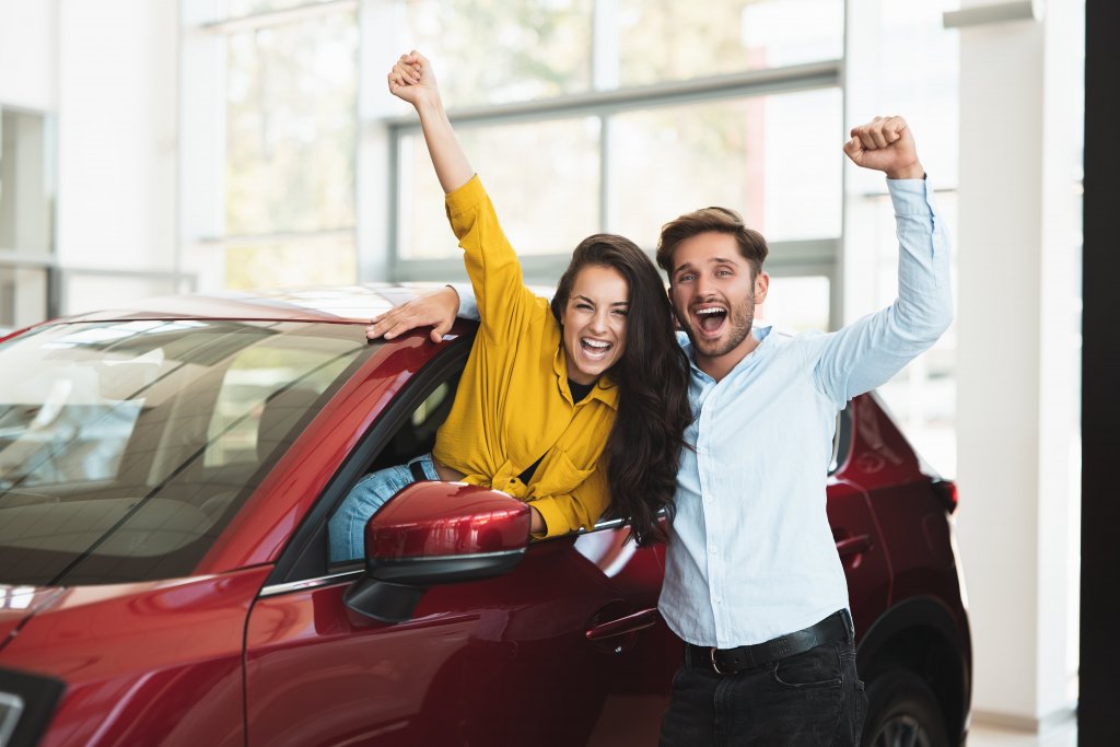 couple excited after buying their first car