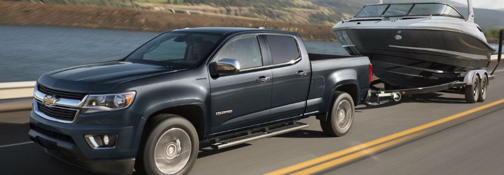 Gray 2018 Chevy Colorado Towing a Boat on a Bridge