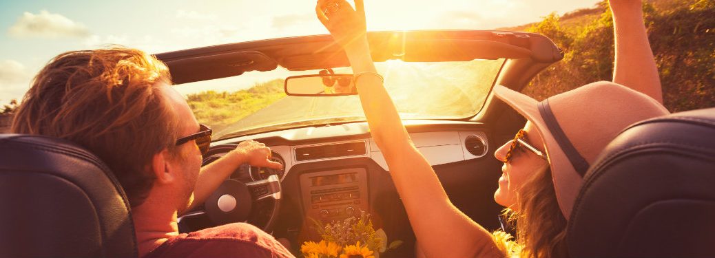 Couple in car at sunset