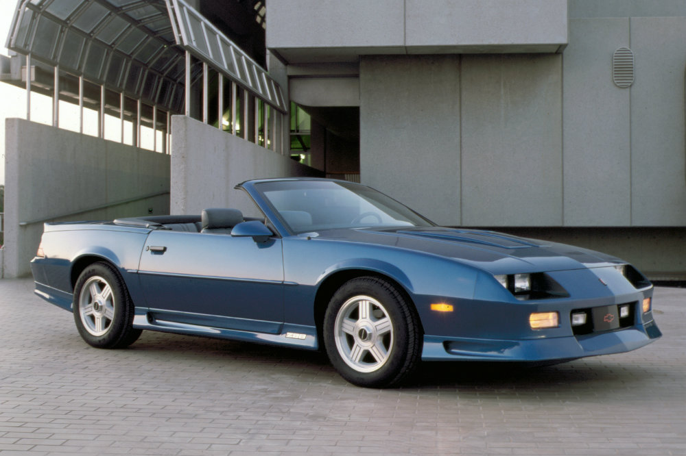 Blue 1992 Chevy Camaro Z28 Convertible with an industrial background