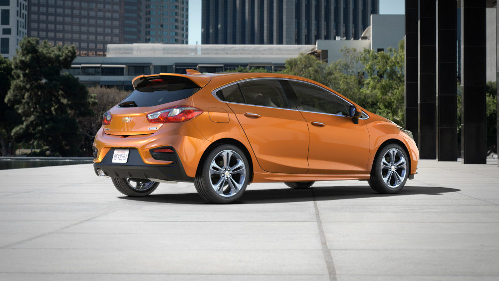 Rear side view of an orange 2017 Chevy Cruze Hatch hatchback