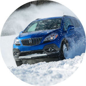 Blue Buick in the middle of cold weather snow driving testing