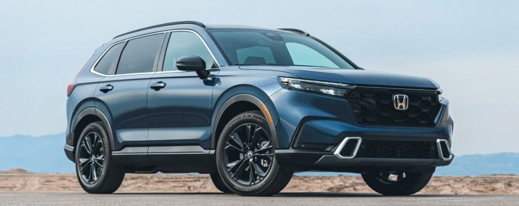 A 2024 Honda CR-V is parked in front of a scenic view, making this a perfect SUV for your family vacation. Shop for your new Honda CR-V at Midlands Honda in Columbia, SC.