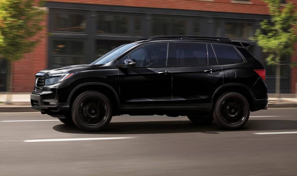 A black 2024 Honda Passport races smoothly down a city street, perfect for exploring all types of terrain with the family. Find your new Honda Passport at Midlands Honda in Columbia, SC.