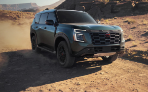A 2025 Nissan Armada drives on a dusty desert road. 