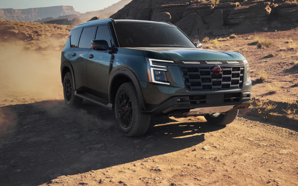 The 2025 Nissan Armada on a dusty desert road.