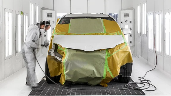 Collision Center Technician Painting a Vehicle 