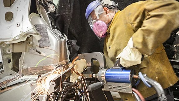 Collision Center Technician Repairing Vehicle 