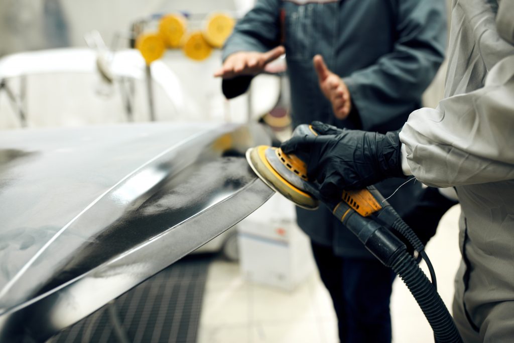 Guy Sanding Car Hood