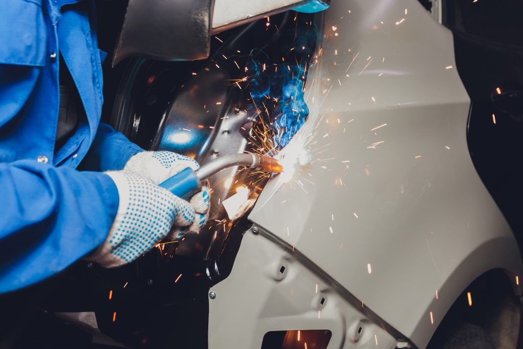 Guy Welding Damaged Car