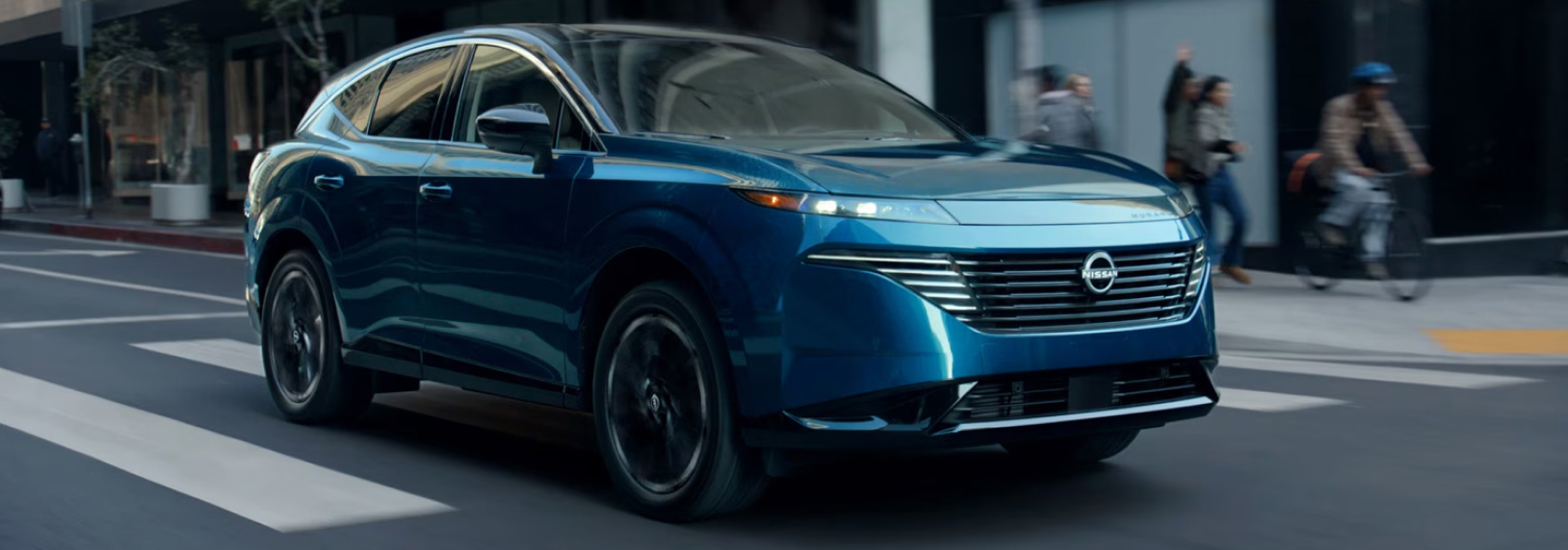 Blue Nissan SUV driving on the city streets