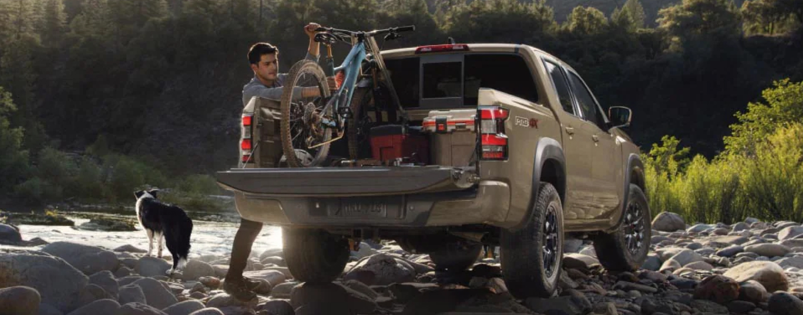 Man dismounting bicycle from pickup truck