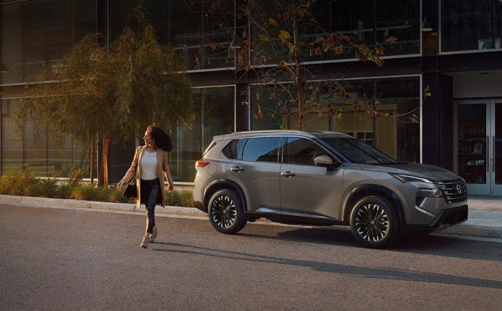 Lady walking away from the parked Nissan SUV