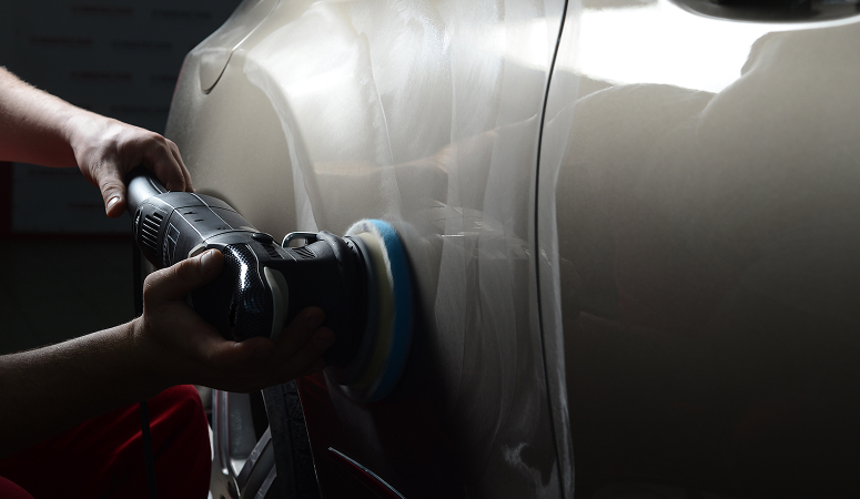 Technician detailing car side