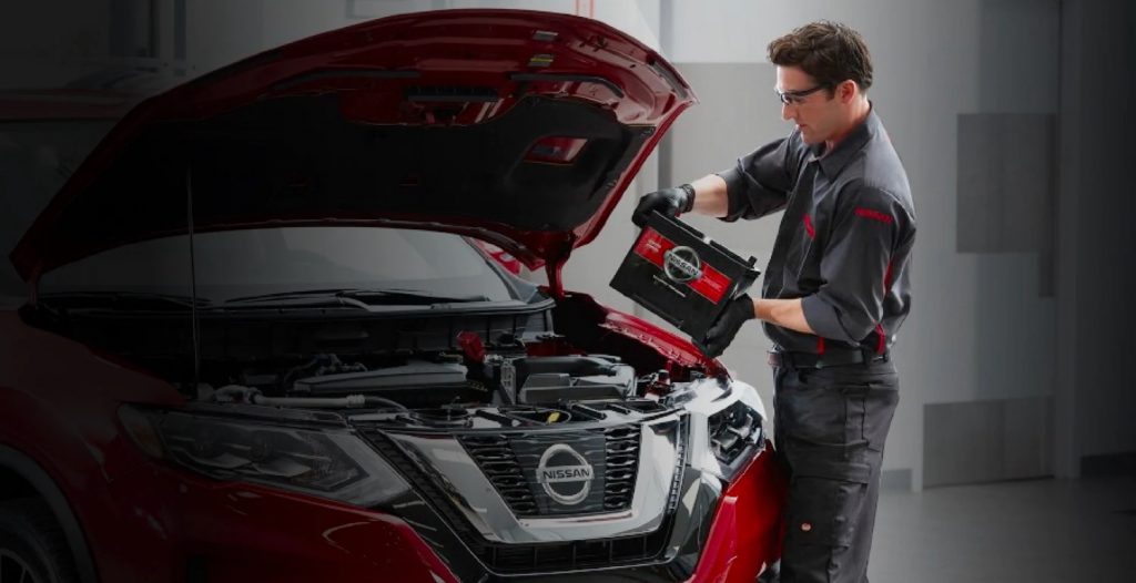 Nissan Technician Replacing Car Battery